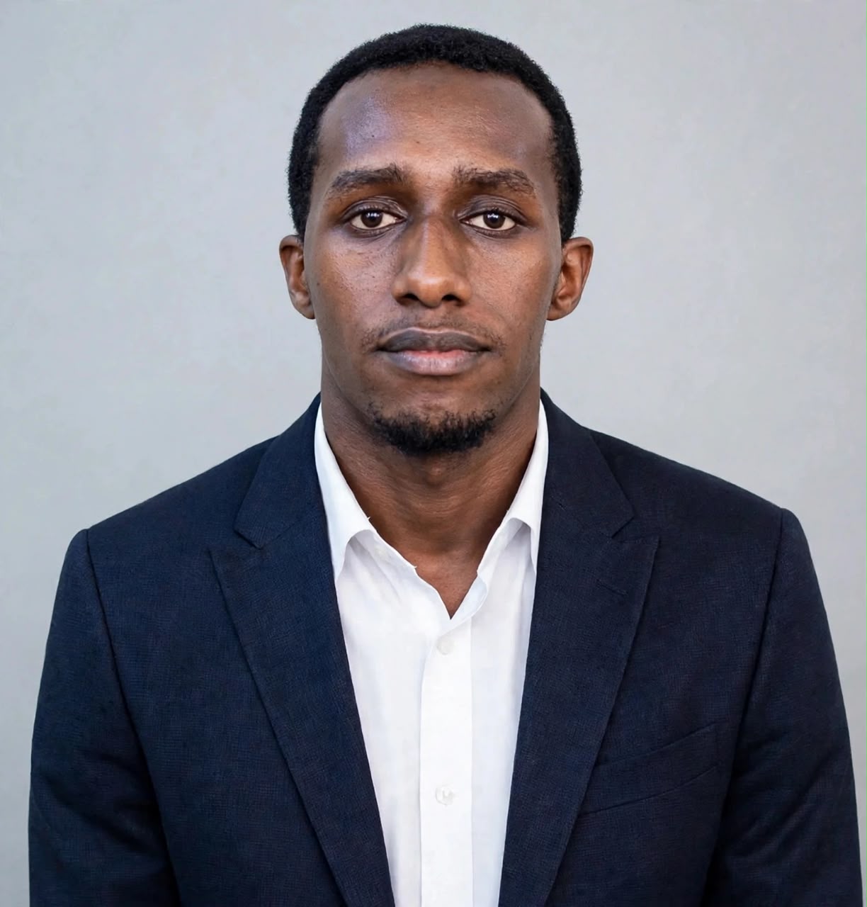 Response Iranzi wearing a dark suit and white shirt